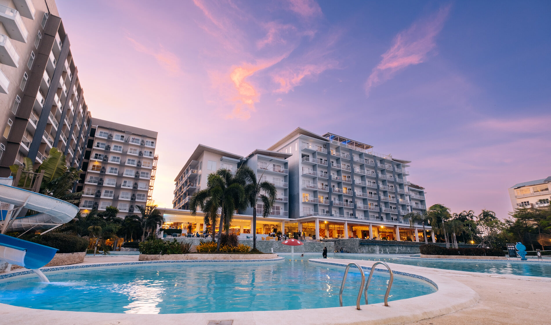 Pool and main building at Solea Mactan Resort and Waterpark.